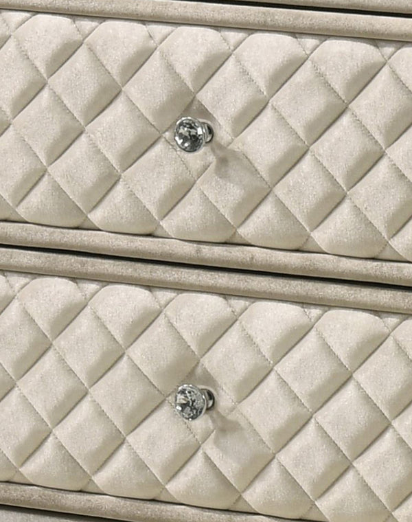 Sonya Beige Velvet Upholstered Traditional Style Dresser Close-up of a quilted cream-colored dresser drawer front with a diamond pattern and a round silver-tone knob.