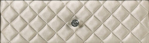 Sonya Beige Velvet Upholstered Traditional Style Dresser A close-up of a quilted cream-colored leather clutch or wallet with a central silver-tone button closure.