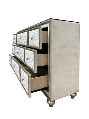 Sonya Beige Velvet Upholstered Traditional Style Dresser A modern 5-drawer dresser with a champagne beige velvet upholstered frame, diamond-quilted drawer fronts, silver knobs, and a clear glass top, shown with two drawers open on a white background.