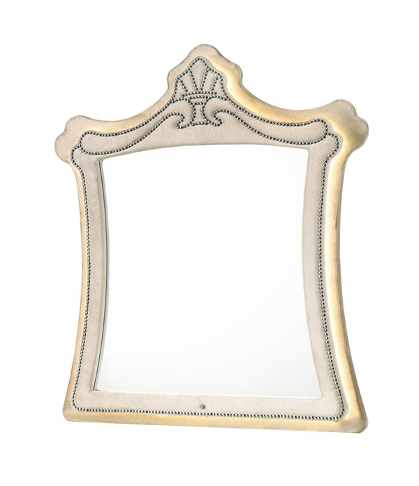 Sonya Beige Velvet Upholstered Traditional Style Mirror An ornate rectangular wall mirror with a decorative frame featuring a scalloped crest at the top, beaded trim, and a warm cream and gold finish, shown on a plain white background.