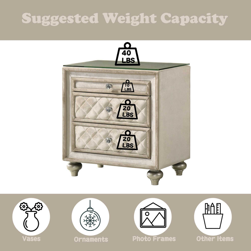 Sonya Beige Velvet Upholstered Traditional Style Nightstand A three-drawer nightstand with a distressed cream and silver finish, featuring quilted diamond-patterned drawer fronts, round silver knobs, and a clear glass top, shown on a plain white background.