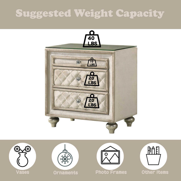 Sonya Beige Velvet Upholstered Traditional Style Nightstand A three-drawer nightstand with a distressed beige/cream finish and a dark green glass top, shown with overlaid weight capacity graphics indicating 40 lbs on the glass top and 20 lbs per drawer. The image includes a top banner reading 'Suggested Weight Capacity' and bottom icons suggesting vases, ornaments, photo frames, and other items.