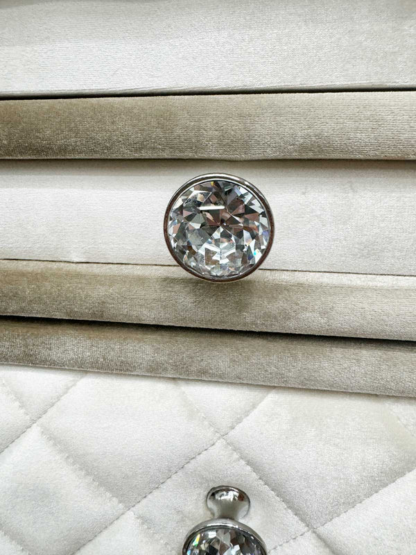 Sonya Beige Velvet Upholstered Traditional Style Nightstand Close-up of a crystal knob on a textured surface