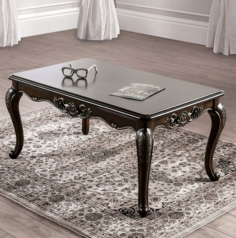 Spencer Solid Wood Traditional Coffee Table Decorative dark wood coffee table with ornate legs on a patterned rug.