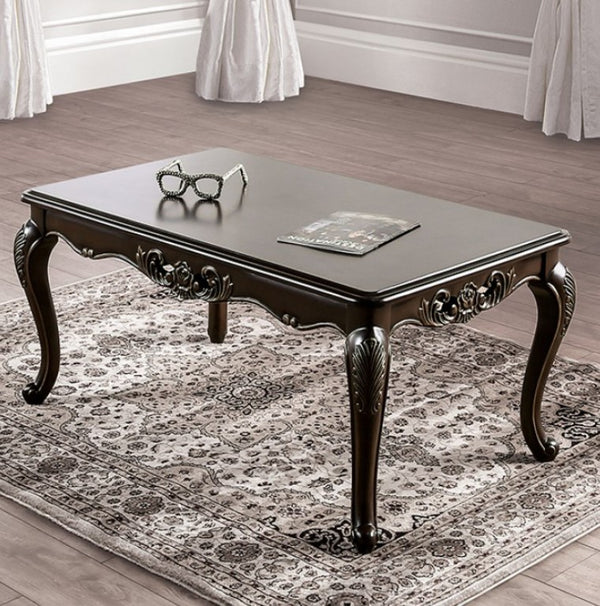 Spencer Solid Wood Traditional Coffee Table Decorative dark wood coffee table with ornate legs on a patterned rug.
