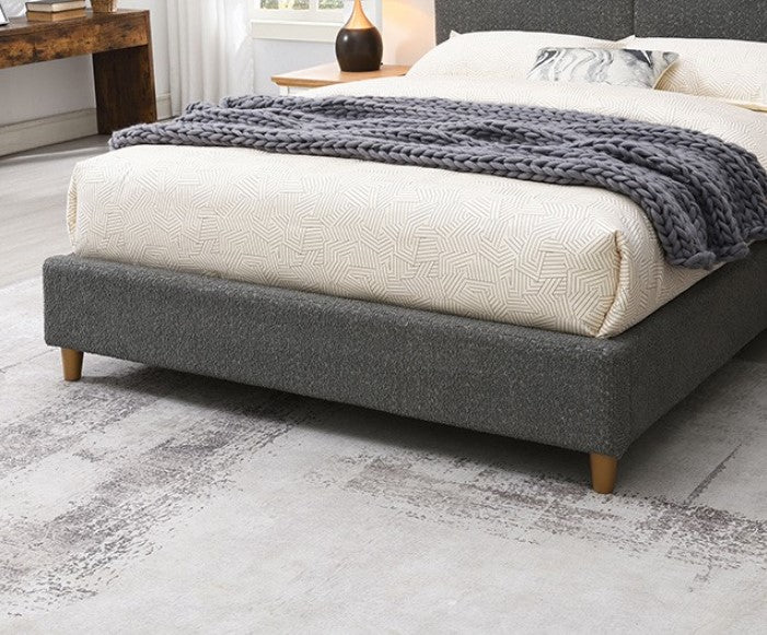 Stivan Bed Fully Upholstered Gray Boucle Fabric Gray upholstered bed in a bedroom with decor elements.