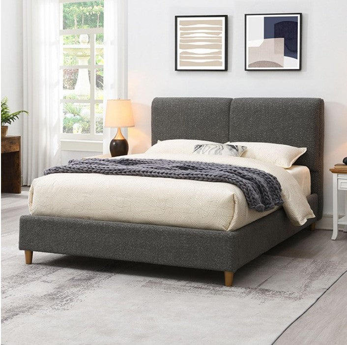 Stivan Bed Fully Upholstered Gray Boucle Fabric Gray upholstered bed in a bedroom with decor elements.
