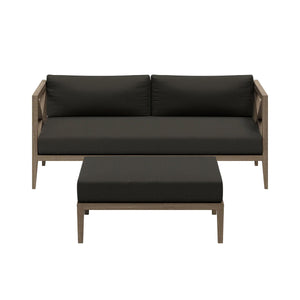 Sunshore Flint Gray Loveseat and Ottoman Outdoor Set Outdoor sofa set with black cushions on a white background