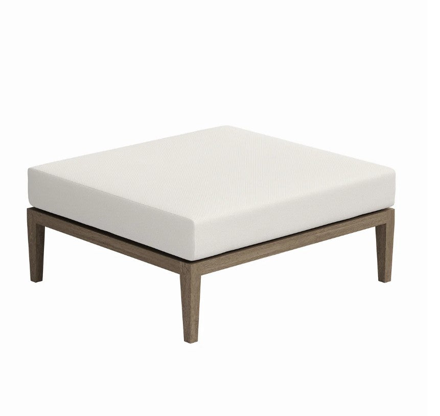 Sunshore Weather Gray Outdoor Ottoman Outdoor patio bench with white cushion on a grassy area with flowers and a chair in the background.