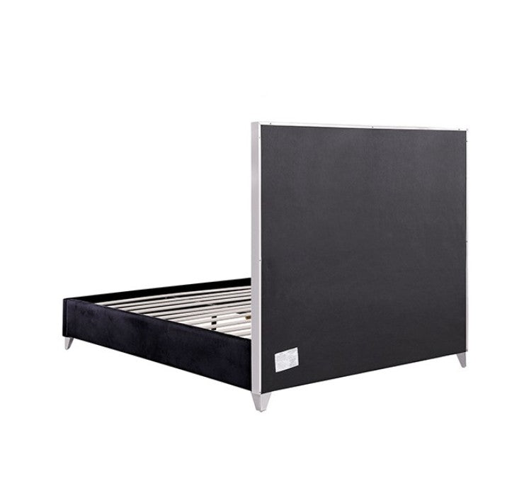 Sysko Glam Black Silver Fully Upholstered Bed A modern black bed frame with a tall segmented headboard, styled in a bedroom with a gray rug, light wood floor, black nightstands, silver lamps, and a circular silver ceiling light.