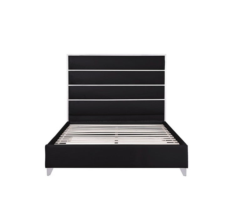 Sysko Glam Black Silver Fully Upholstered Bed A modern black bed frame with a tall segmented headboard, styled in a bedroom with a gray rug, light wood floor, black nightstands, silver lamps, and a circular silver ceiling light.