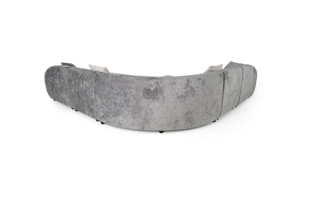 Tiarra Corner Sectional Sofa Fabric Gray A curved modular upholstered sofa in a textured light gray fabric, styled with four neutral throw pillows, shown against a plain white background.