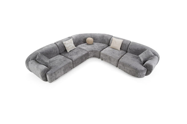 Tiarra Corner Sectional Sofa Fabric Gray A curved modular sectional sofa upholstered in textured gray fabric, featuring four light beige throw pillows and a small round beige accent pillow, shown on a plain white background.