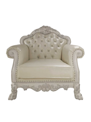 Traditional Style Chair Bone White Dresden Collection An ornate vintage-style armchair with a tufted cream leather seat and backrest, featuring carved white wood detailing and nailhead trim, isolated on a white background.