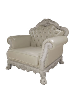 Traditional Style Chair Bone White Dresden Collection A classic French chaise lounge armchair featuring cream-colored tufted leather upholstery and ornate, carved white wood arms and frame with nailhead trim.