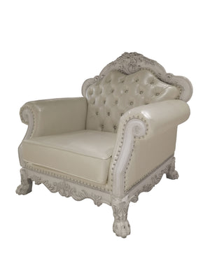 Traditional Style Chair Bone White Dresden Collection A classic French chaise lounge armchair featuring cream-colored tufted leather upholstery and ornate, carved white wood arms and frame with nailhead trim.