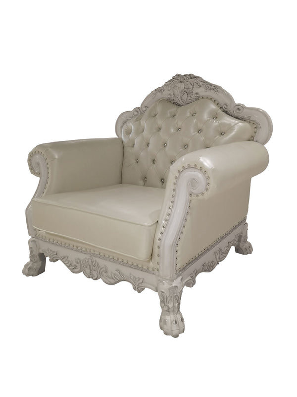 Traditional Style Chair Bone White Dresden Collection A classic French chaise lounge armchair featuring cream-colored tufted leather upholstery and ornate, carved white wood arms and frame with nailhead trim.