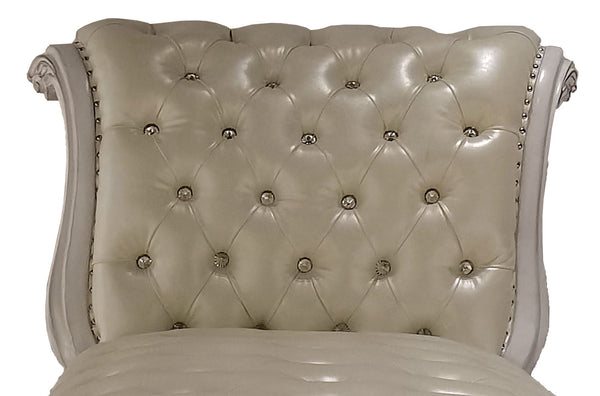 Traditional Style Chaise Bone White Dresden Collection Close-up of a tufted upholstered chair back in warm ivory or cream leather, with decorative nailhead trim and carved side arms visible against a plain white background.