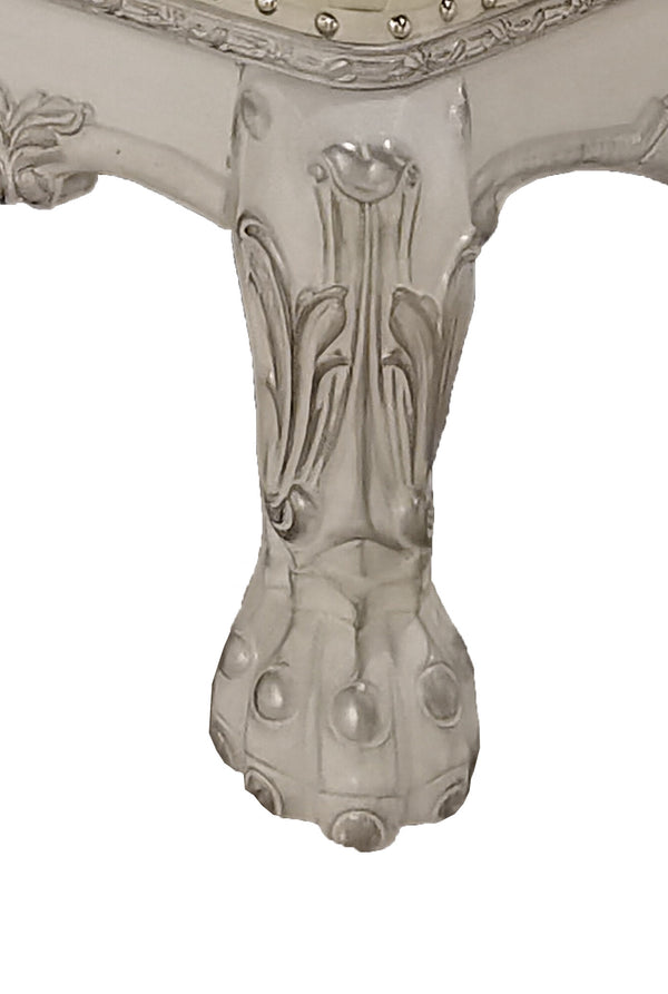 Traditional Style Chaise Bone White Dresden Collection Close-up of an ornate carved table leg in a light gray finish, showing decorative scrollwork and a claw-foot style base on a plain white background.