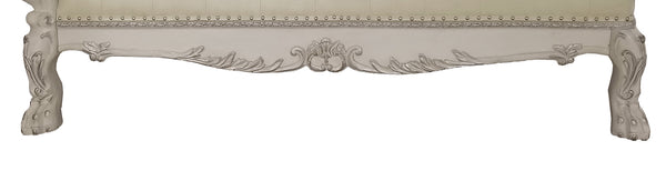 Traditional Style Chaise Bone White Dresden Collection Close-up of an ornate upholstered bench or seat with carved decorative details and carved legs, shown against a plain white background.