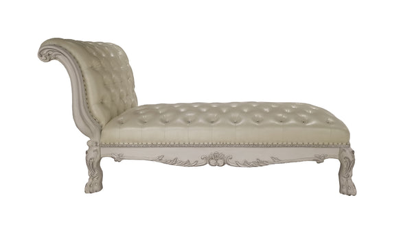 Traditional Style Chaise Bone White Dresden Collection An elegant chaise lounge with a tufted cream leather seat and a carved light beige wood frame, shown against a plain white background.