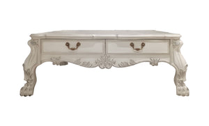 Traditional Style Coffee Table Bone White Dresden Collection An ornate white carved coffee table with two drawers, featuring gold-toned metal handles and decorative cabriole-style legs, shown against a plain white background.