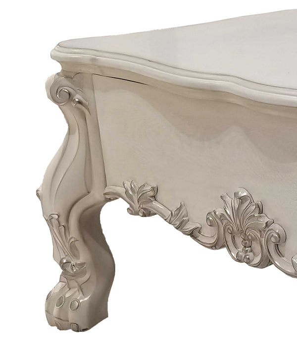 Traditional Style Coffee Table Bone White Dresden Collection Close-up of an ornate white carved furniture piece, showing a cabriole-style leg and decorative scrollwork on a plain white background.