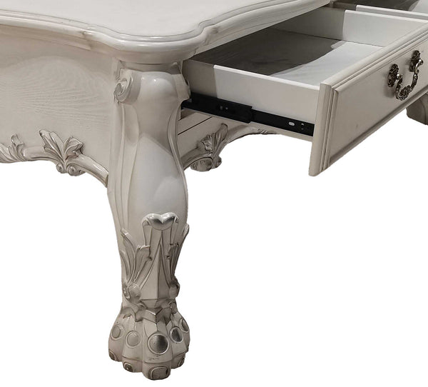 Traditional Style Coffee Table Bone White Dresden Collection Close-up of an ornate white carved wooden desk with a drawer pulled open, showing decorative cabriole-style legs and silver drawer pulls against a white background.