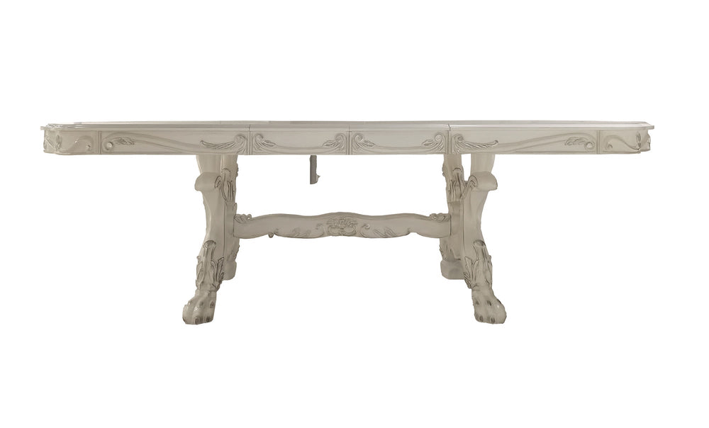 Traditional Style Dining Table Bone White Dresden Collection Elegant dining room with silver and white furniture, including a table and chairs, in a luxurious setting.