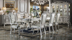 Traditional Style Dining Table Bone White Dresden Collection Elegant dining room with silver and white furniture, including a table and chairs, in a luxurious setting.