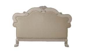 Traditional Style Loveseat Bone White Dresden Collection An ornate upholstered headboard with a curved, baroque-style frame, featuring carved details and clawfoot legs, shown against a plain white background.