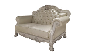 Traditional Style Loveseat Bone White Dresden Collection An ornate cream-colored loveseat sofa with carved wood details, button-tufted upholstery, and nailhead trim, shown against a plain white background.