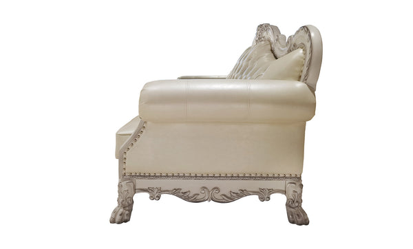 Traditional Style Sofa Bone White Dresden Collection An elegant cream-colored faux leather loveseat with ornate silver carved legs and trim, shown from a three-quarters angle against a white background.