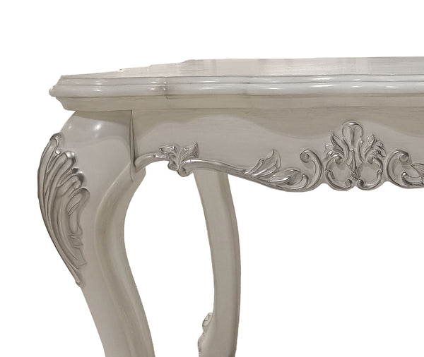 Traditional Style End Table Bone White Dresden Collection Close-up of an ornate white carved table leg with decorative silver-toned scrollwork and a smooth white tabletop on a white background.