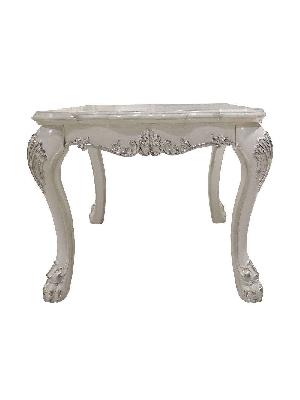 Traditional Style End Table Bone White Dresden Collection An ornate white carved console table with cabriole legs and floral scroll details, styled with a vase of white flowers and books in a room with a gray wall and marble floor.
