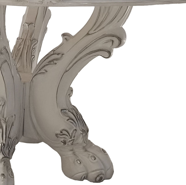 Traditional Style Round Dining Table Bone White Dresden Collection Close-up of an ornate carved table leg in a distressed white finish, showing detailed scrollwork and a clawfoot-style base on a plain white background.