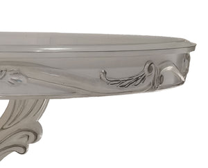Traditional Style Round Dining Table Bone White Dresden Collection Close-up of a glossy white console table corner showing ornate carved details and a curved support leg against a plain white background.