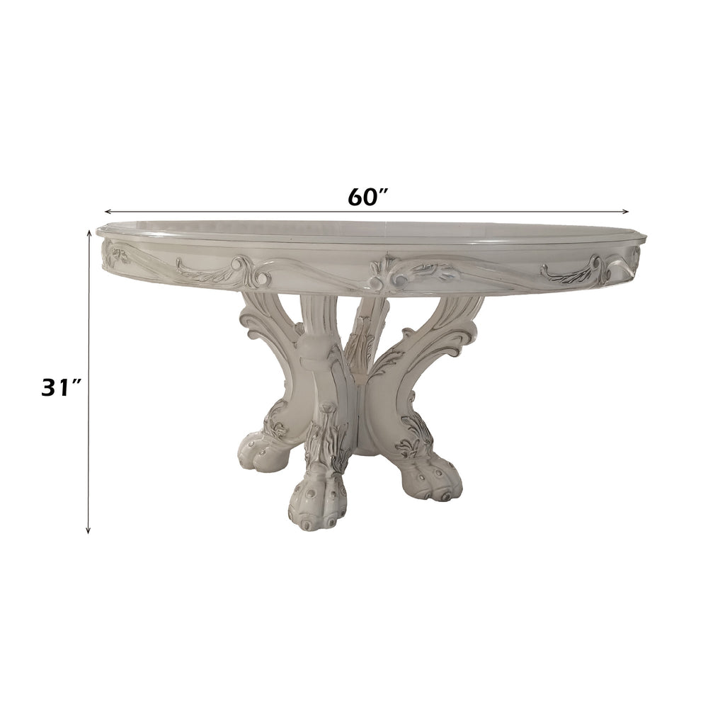 Traditional Style Round Dining Table Bone White Dresden Collection An ornate white carved dining room set featuring a round table and six matching high-back chairs with tufted upholstery, shown in a decorated dining room setting with a blue patterned rug and chandelier.