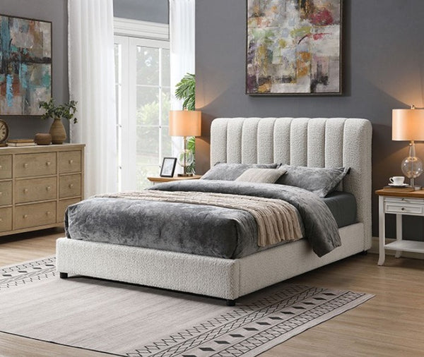 Traver Padded Vertical Channel Headboard Bed White Neatly made bed in a bedroom with abstract art on the walls and a rug on the floor.