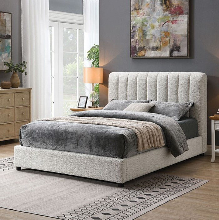 Traver Padded Vertical Channel Headboard Bed White Gray upholstered bed in a bedroom with abstract art on the walls.