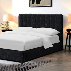 Traver Padded Vertical Channel Headboard Bed White Black upholstered bed with white bedding in a bedroom setting