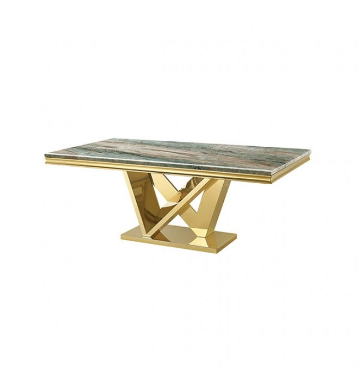 Valdi Gold Gray Sintered Stone Top Dining Table A rectangular dining table with a polished gold metallic base and a gray marble top, styled in a bright, modern dining room with a gold chandelier, light wood floors, and a potted tree.