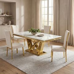 Valdi Gold White Sintered Stone Top Dining Table A modern dining set featuring a rectangular marble-top table with a geometric gold metallic base and four matching cream upholstered chairs with gold legs, styled in a bright, contemporary dining room.