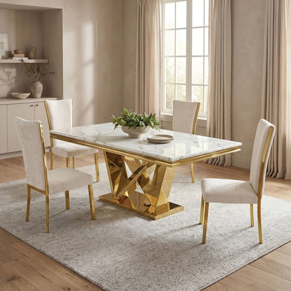 Valdi Gold White Sintered Stone Top Dining Table A modern dining set featuring a rectangular marble-top table with a geometric gold metallic base and four matching cream upholstered chairs with gold legs, styled in a bright, contemporary dining room.