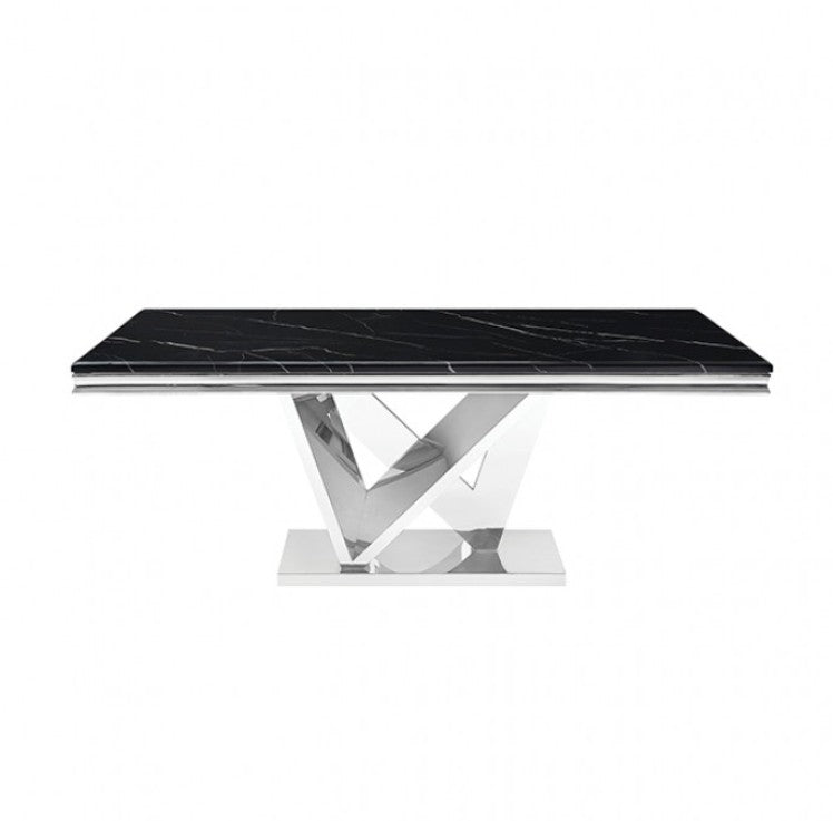 Valdi Silver Black Sintered Stone Top Dining Table A modern rectangular dining table with a glossy black top and a polished chrome geometric X-shaped pedestal base, styled in a bright, elegant dining room with beige paneled walls and marble floors.