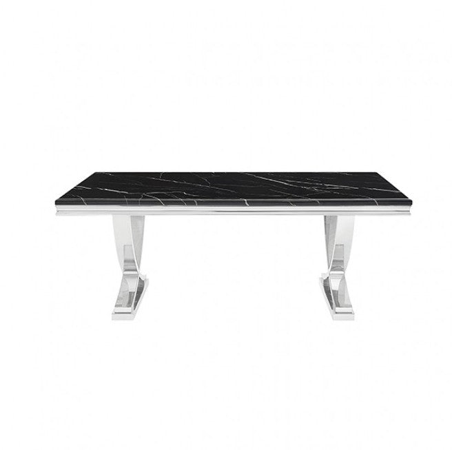 Valdi Silver Black Sintered Stone Top V-Style Pedestal Dining Table A rectangular dining table with a glossy black marble top and polished silver metal legs, styled on a light beige rug in a modern room with wood floors and paneled walls.