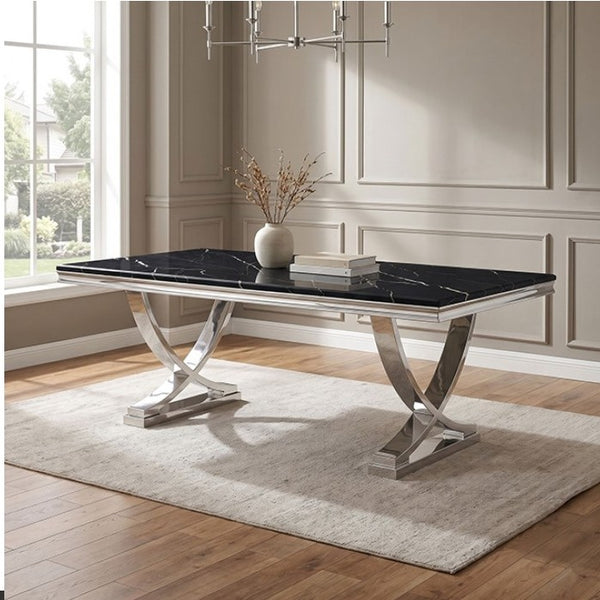 Valdi Silver Black Sintered Stone Top V-Style Pedestal Dining Table A rectangular dining table with a glossy black marble top and polished silver metal legs, styled on a light beige rug in a modern room with wood floors and paneled walls.