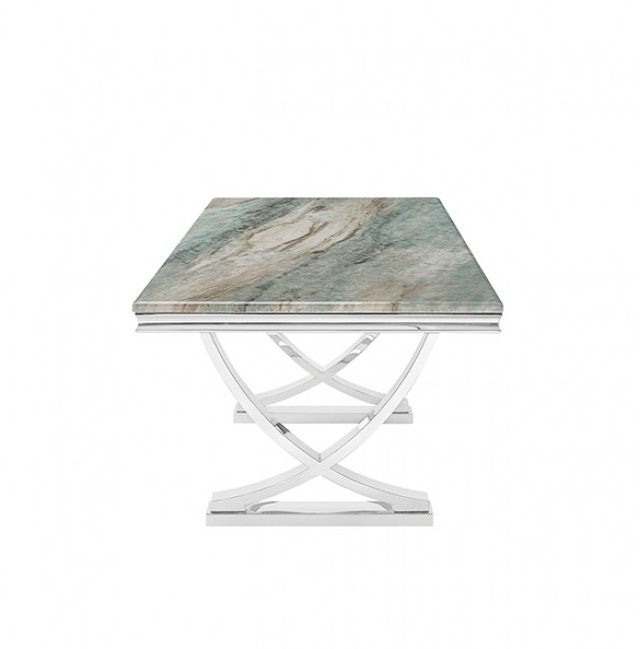Valdi Silver Gray Sintered Stone Top V-Style Pedestal Dining Table A rectangular dining table with a polished silver chrome base and a gray marble-patterned top, styled in a bright room with a beige rug, wood floors, and a window.