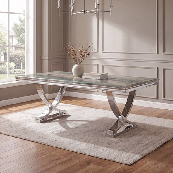 Valdi Silver Gray Sintered Stone Top V-Style Pedestal Dining Table A rectangular dining table with a polished silver chrome base and a gray marble-patterned top, styled in a bright room with a beige rug, wood floors, and a window.