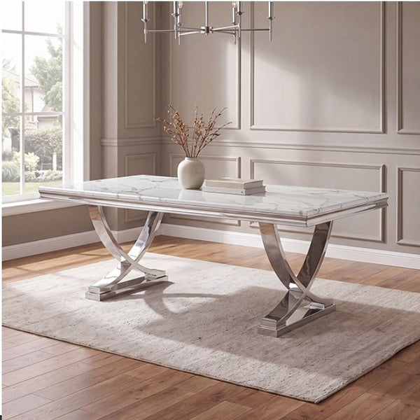 Valdi Silver White Sintered Stone Top V-Style Pedestal Dining Table A rectangular dining table with a white marble-look top and polished silver metal pedestal legs, styled in a bright dining room on a light rug over hardwood floors.